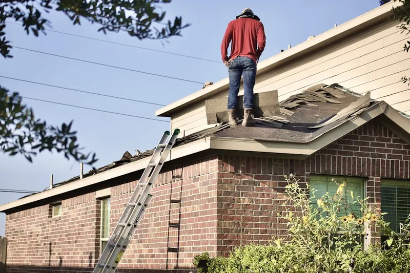 Professional roofer working on a residential roof in Wake Village